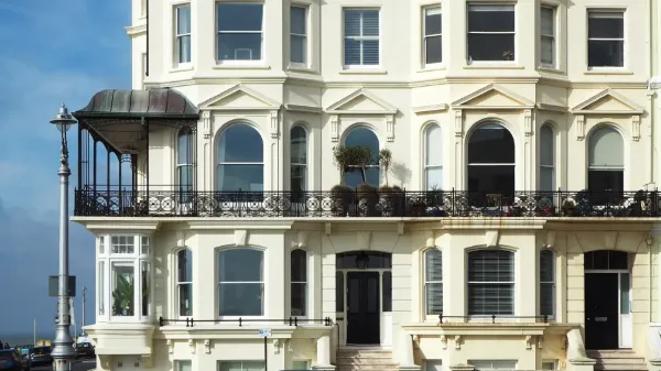 georgian flats painted in a light colour with a clear blue sky int background