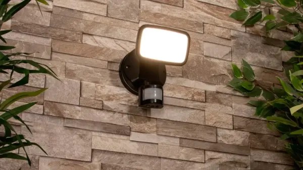 an outdoor security light fixed to a tiled wall